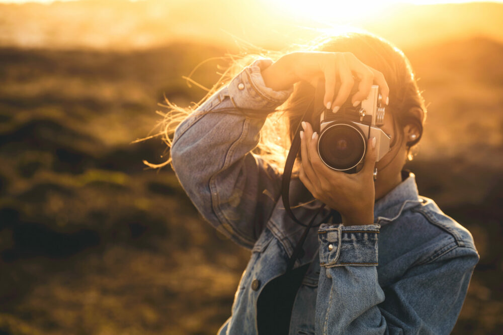 Woman Taking Picture Outdoors Beautiful woman taking picture outdoors with a analog camera